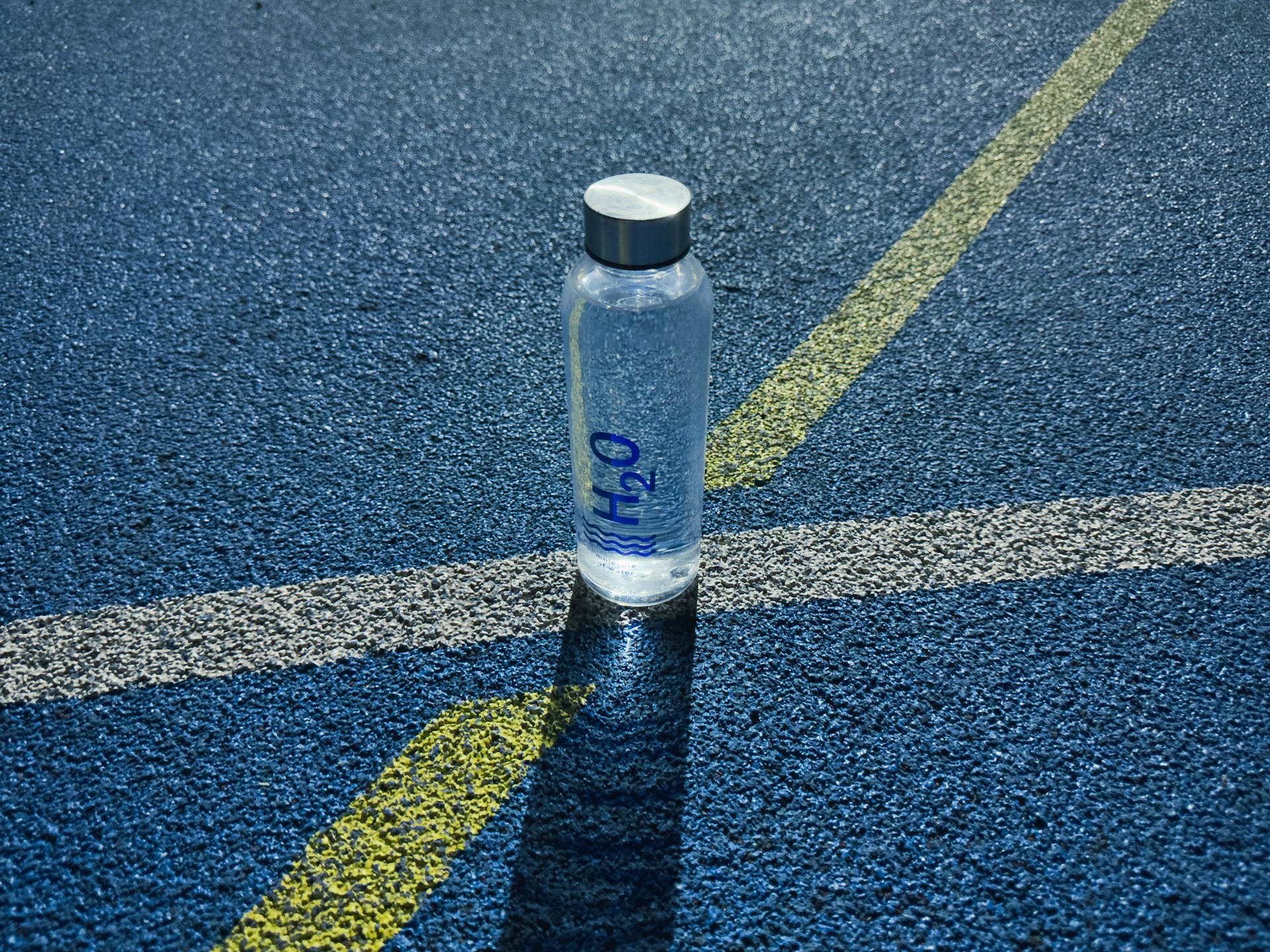 a water bottle sitting on the side of a road